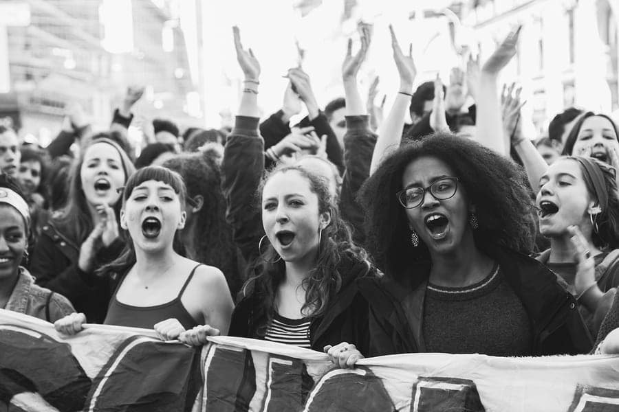 students take part in a march to celebrate the International Women's Day